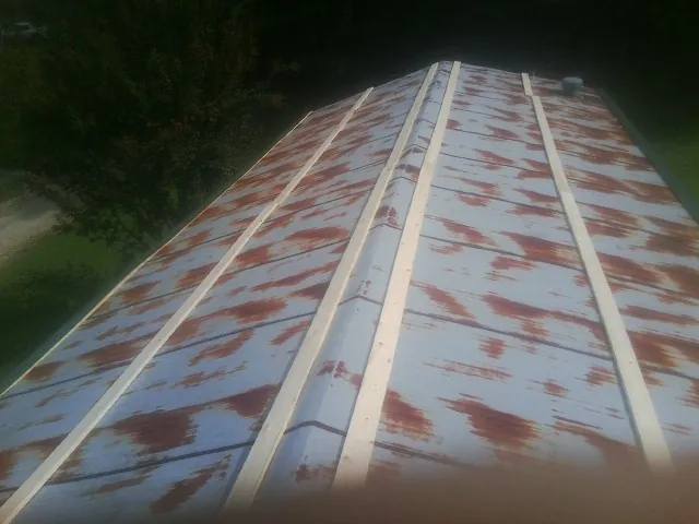Rusted metal roof panels with new wood purlins before replacement — Storm Damage Roof Repair in Woolwich by Roofing Brothers