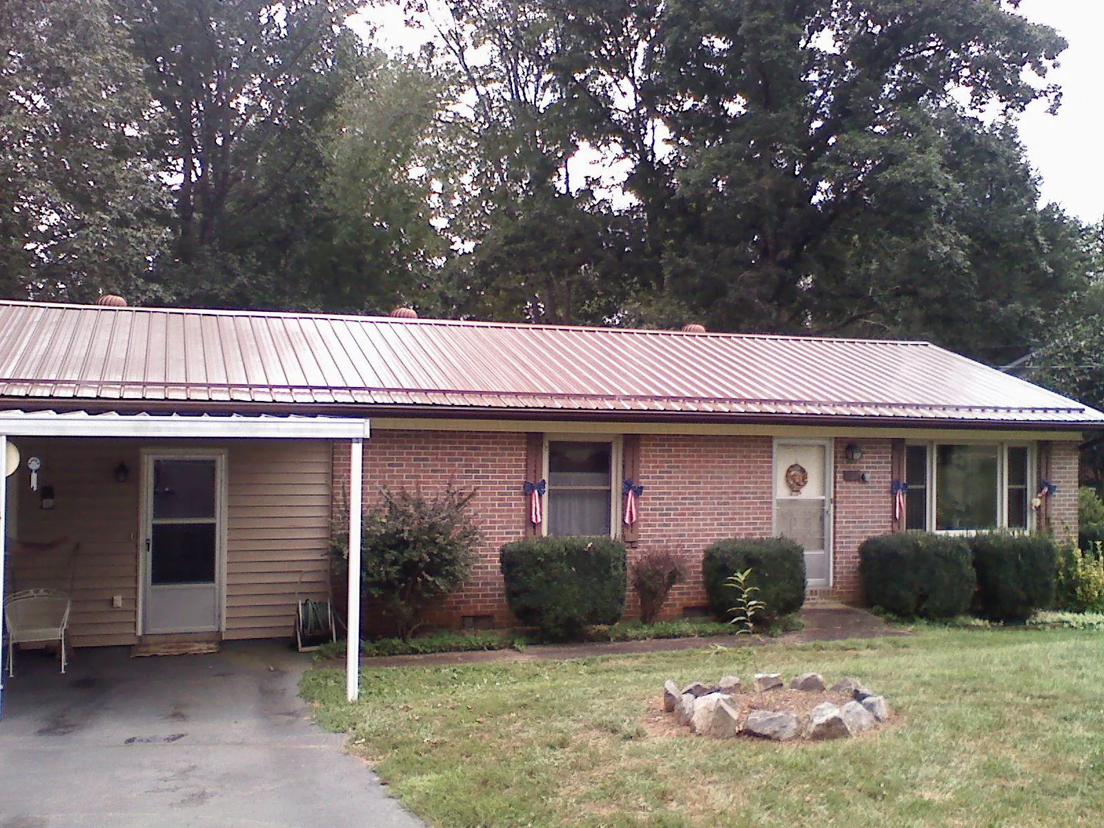 Bronze metal roof and carport on a brick ranch home — Roof Repair work by our crew in Woolwich