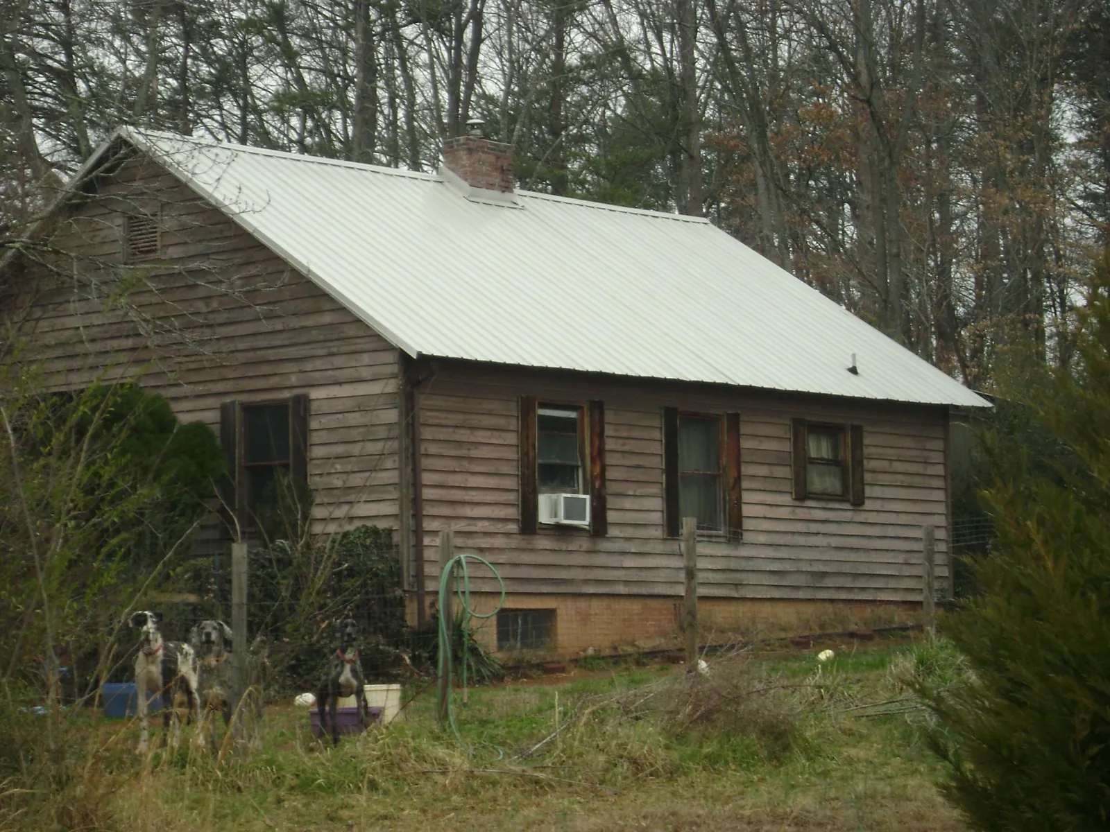 White metal roof on an old wood sided farmhouse, from a Metal Roof Installation job in Woolwich